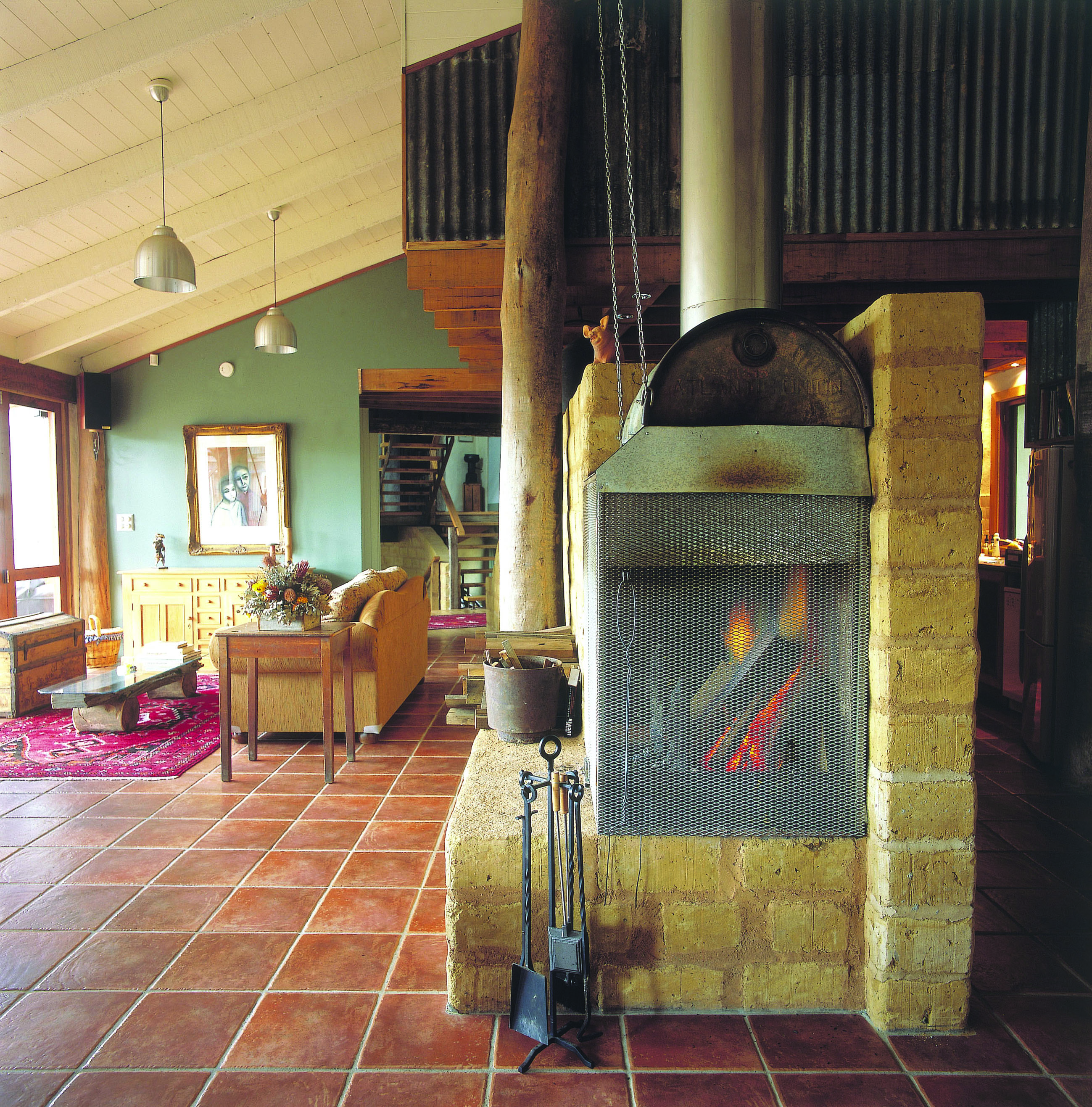 Old Leura Dairy New South Wales straw lounge area with sofa and log fire