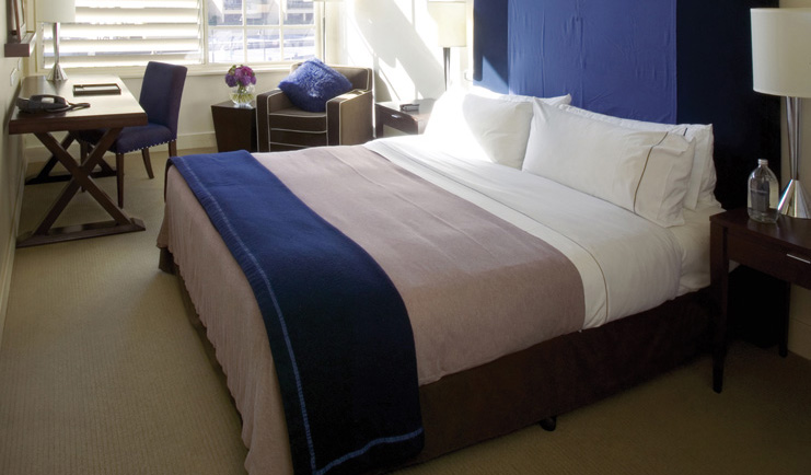 Ovolo Woolloomooloo Sydney bedroom with desk and armchair