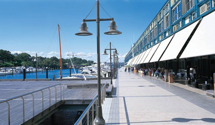 Ovolo Woolloomooloo Sydney exterior marina view of building with awnings next to a marina