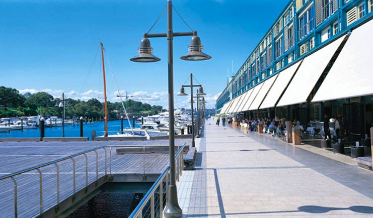 Ovolo Woolloomooloo Sydney exterior marina view of building with awnings next to a marina