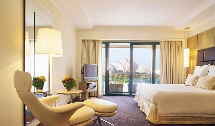 Park Hyatt Sydney bedroom with leather recliner and view of Sydney opera house