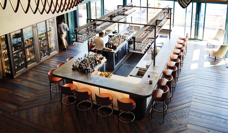 Bar area with high stools around the rectangular bar