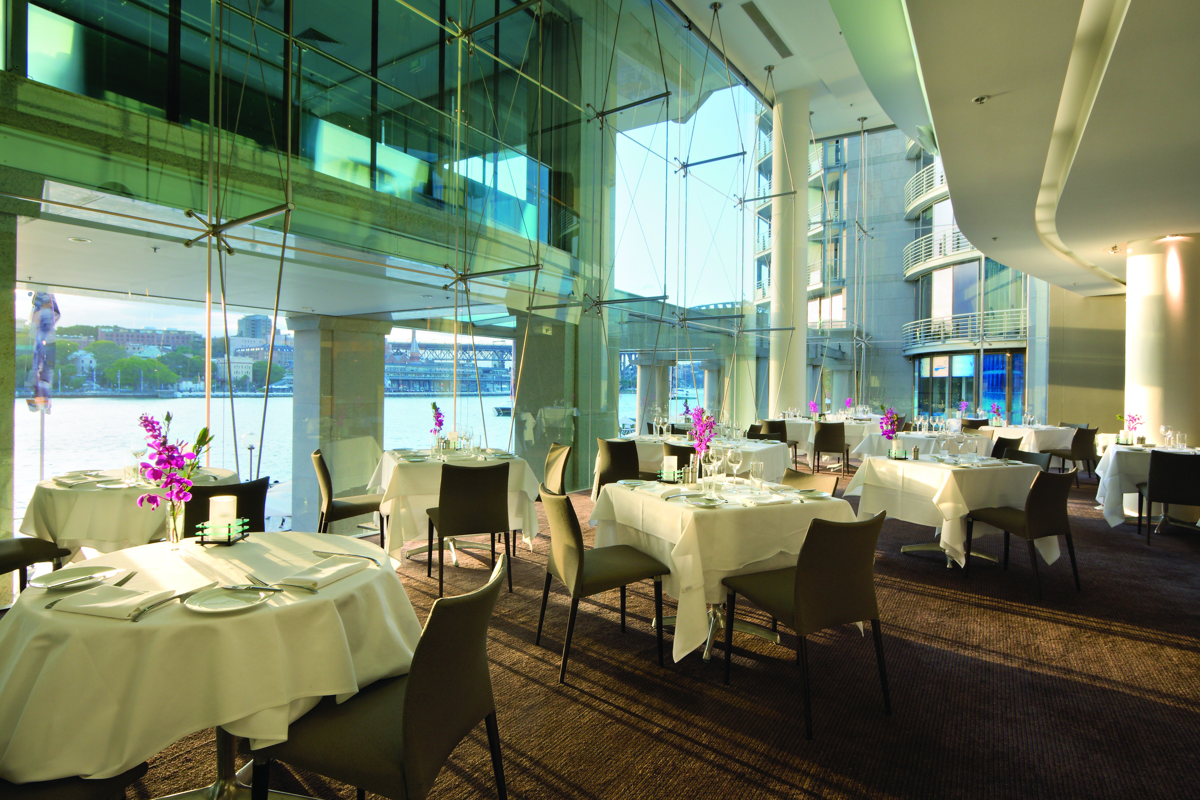 Pullman Grand Quay Sydney restaurant with floor to ceiling windows and harbour view
