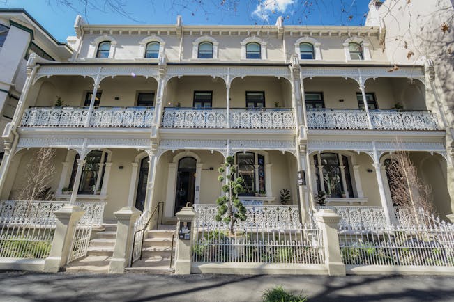 Spicers Potts Point exterior, a large cream building with arching windows and white balcony railings