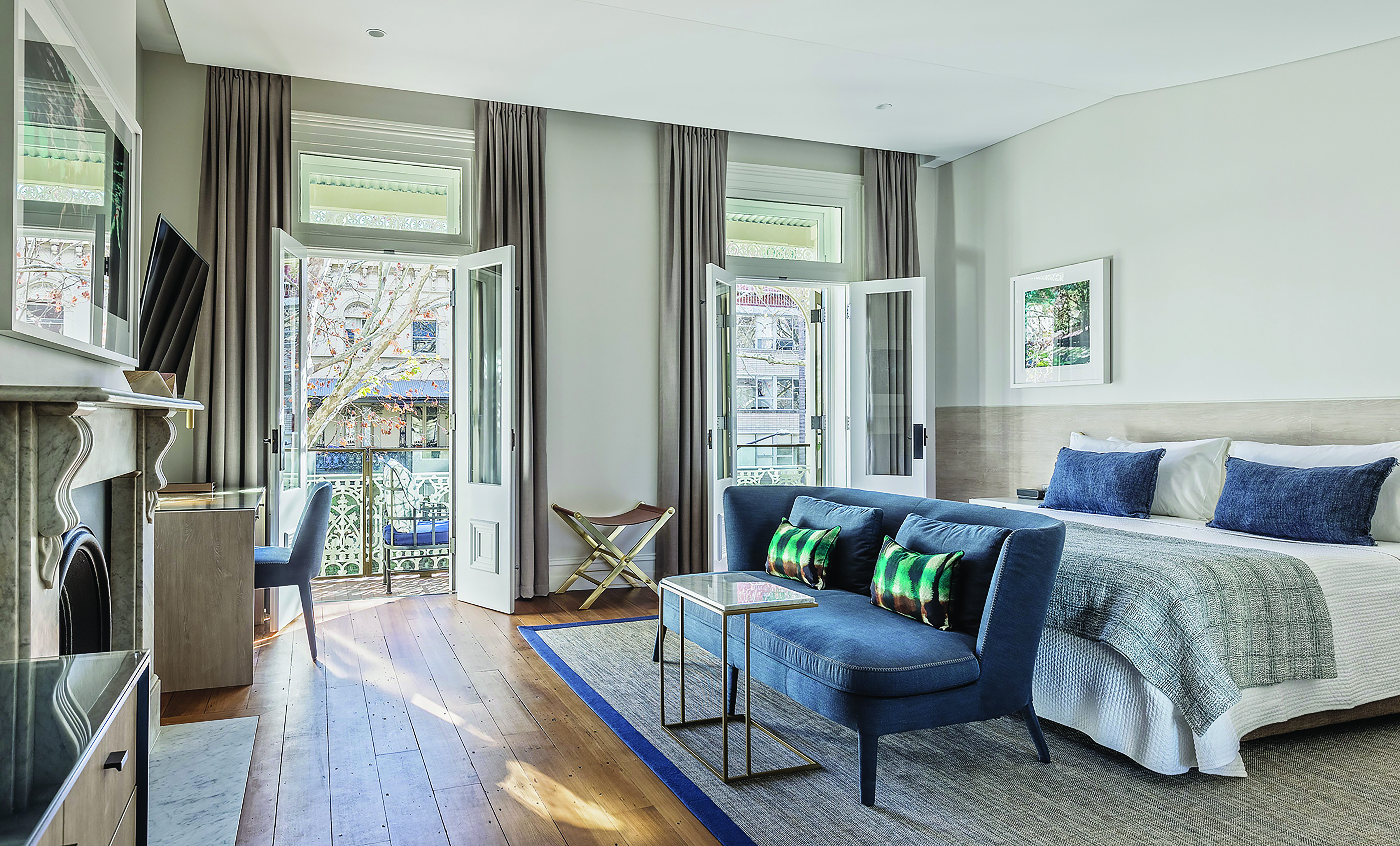 Spicers Potts Point view from a terrace suite with large double bed, and windows opening onto a balcony