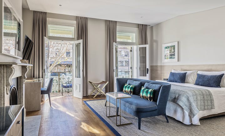 Spicers Potts Point view from a terrace suite with large double bed, and windows opening onto a balcony