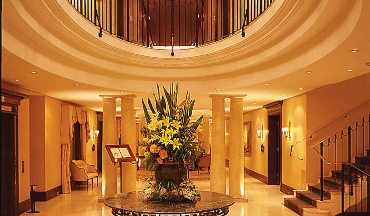 The Langham Sydney lobby area with columns and staircase