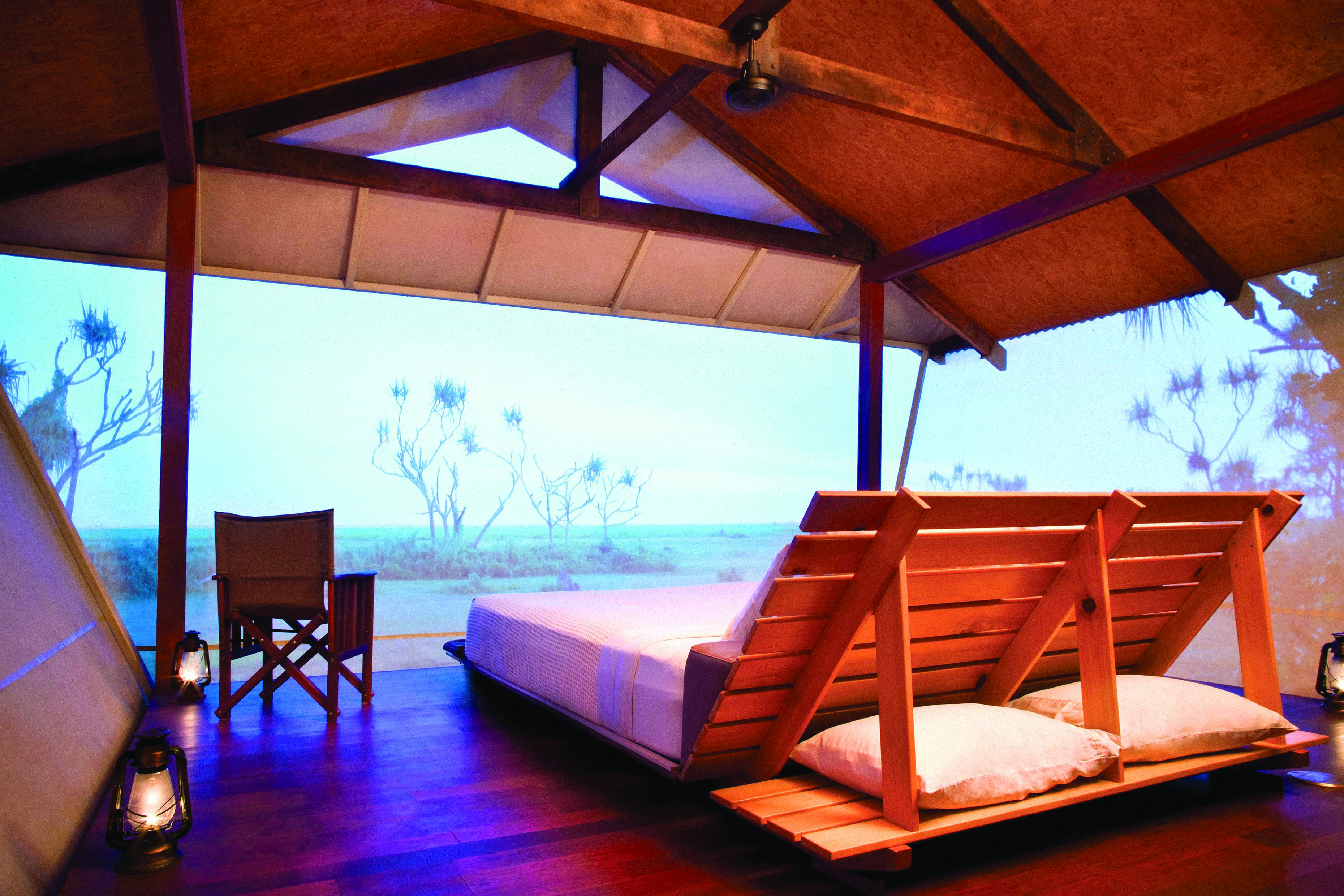 Bamurru Plains lodge interior, double futon bed, netted walls overlooking outback
