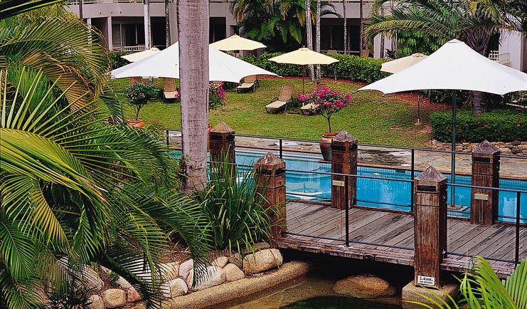 Alamanda Palm Cove Queensland outdoor pool with  wooden bridge loungers and umbrellas