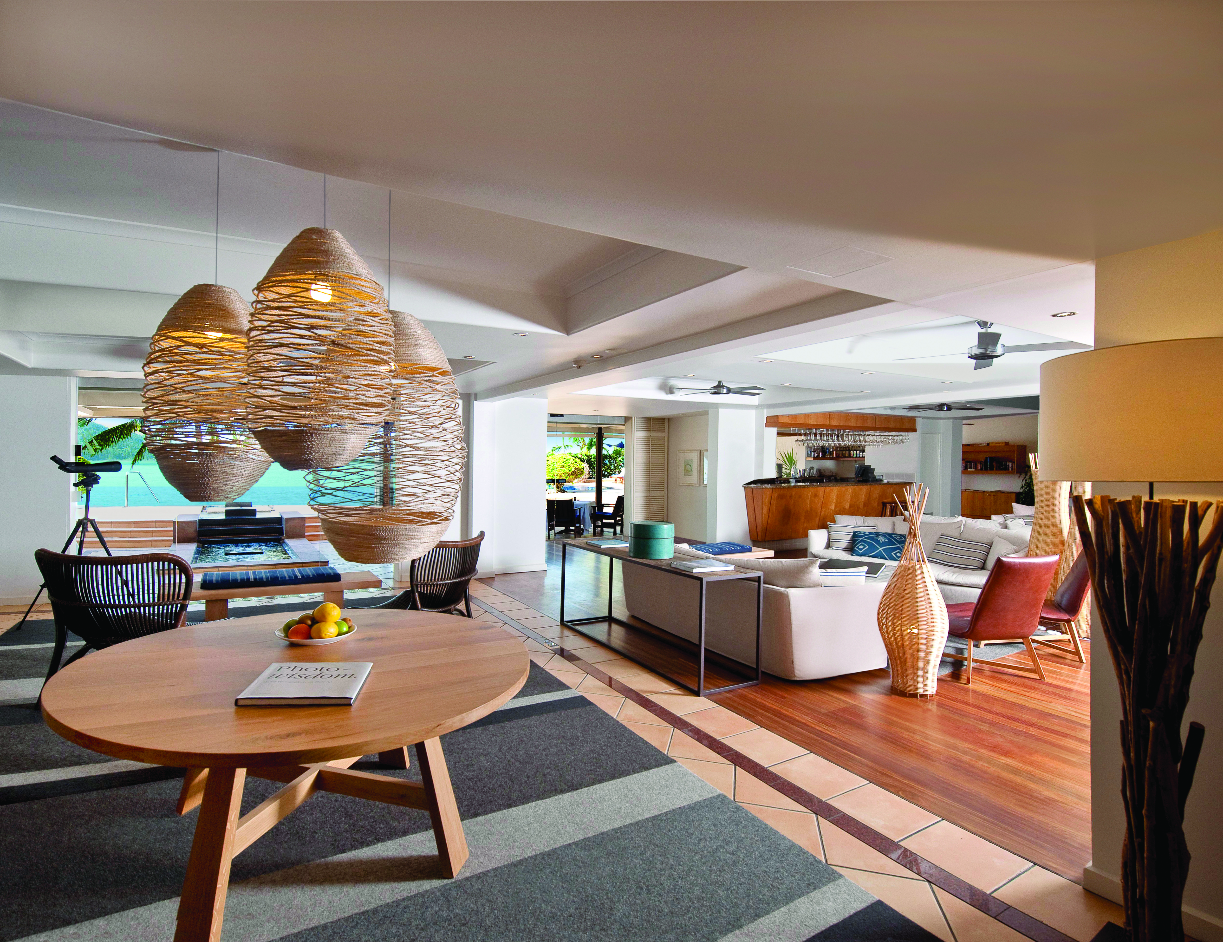 Beach Club Hamilton lounge, communal seating area with sofas, table and chairs, bright modern decor