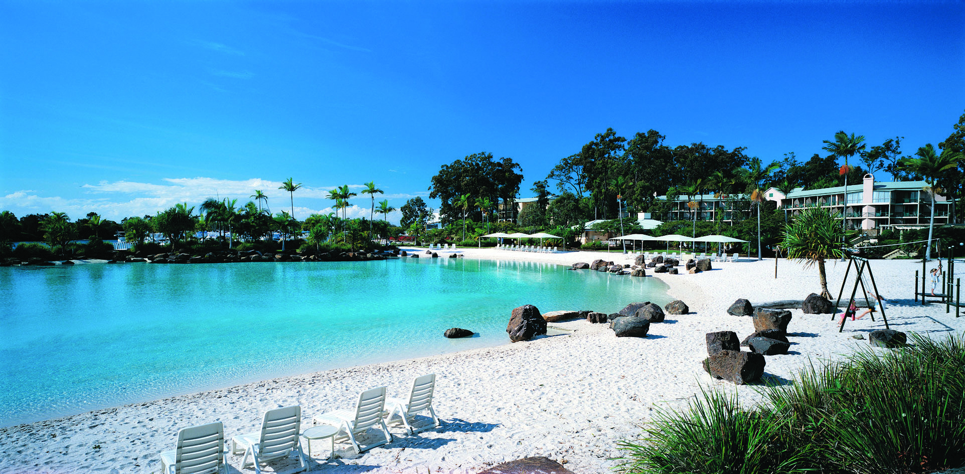 Intercontinental Sanctuary Cove lagoon with blue waters and white sand