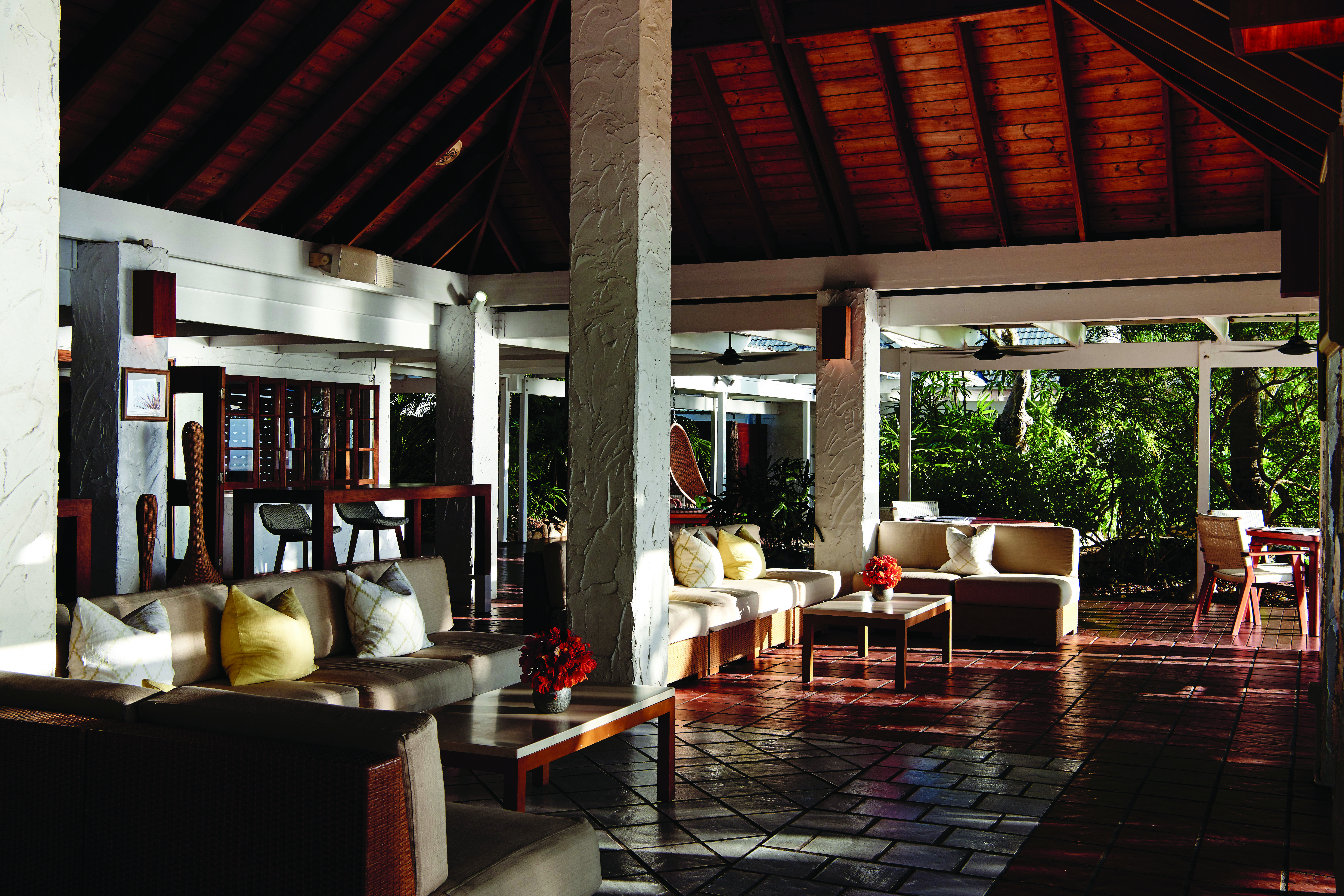 Orpheus Island bar, indoor drinking area with tables, chairs and sofas, modern decor with wood accents