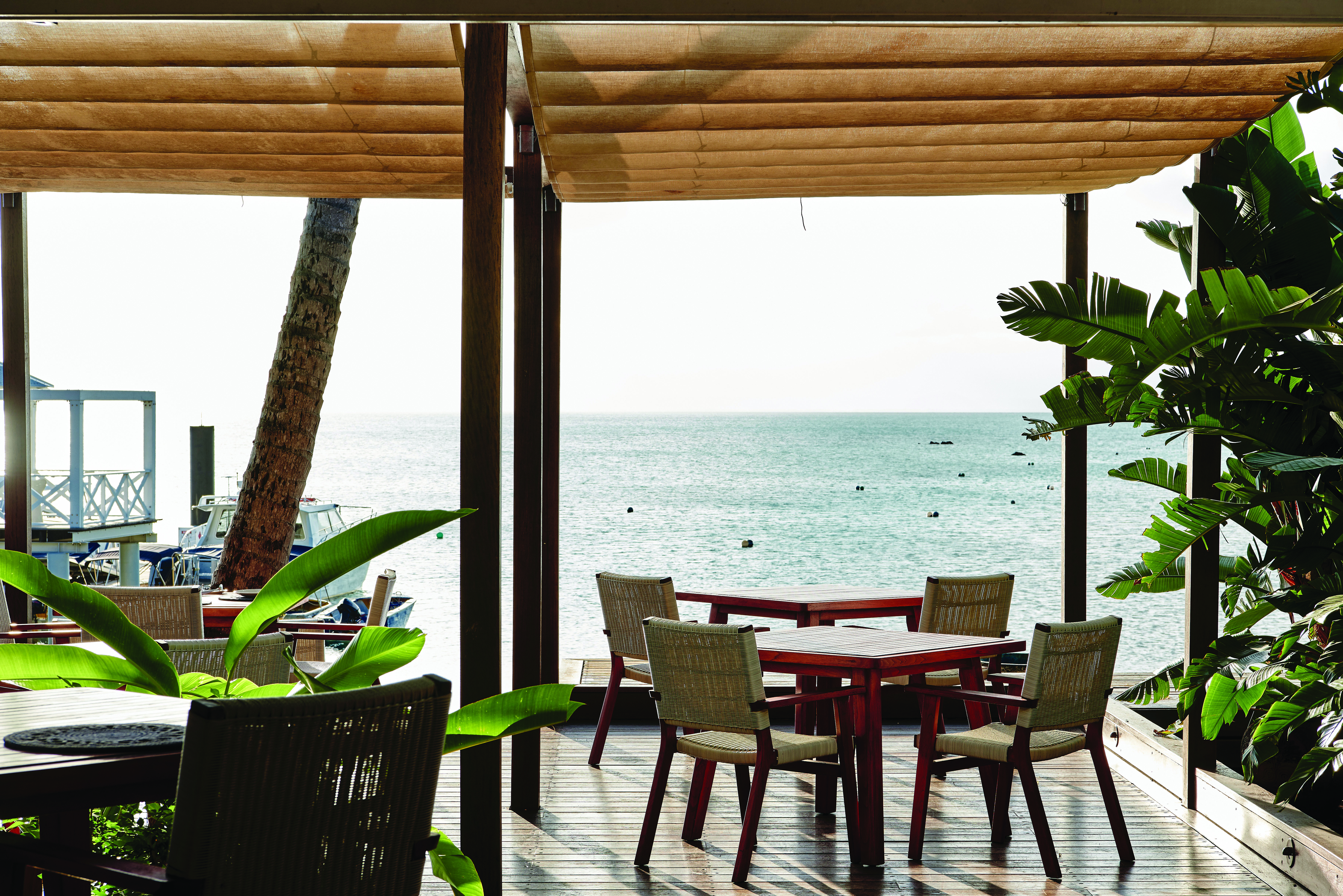 Orpheus Island dining terrace, covered dining area with tables and chairs overlooking the sea