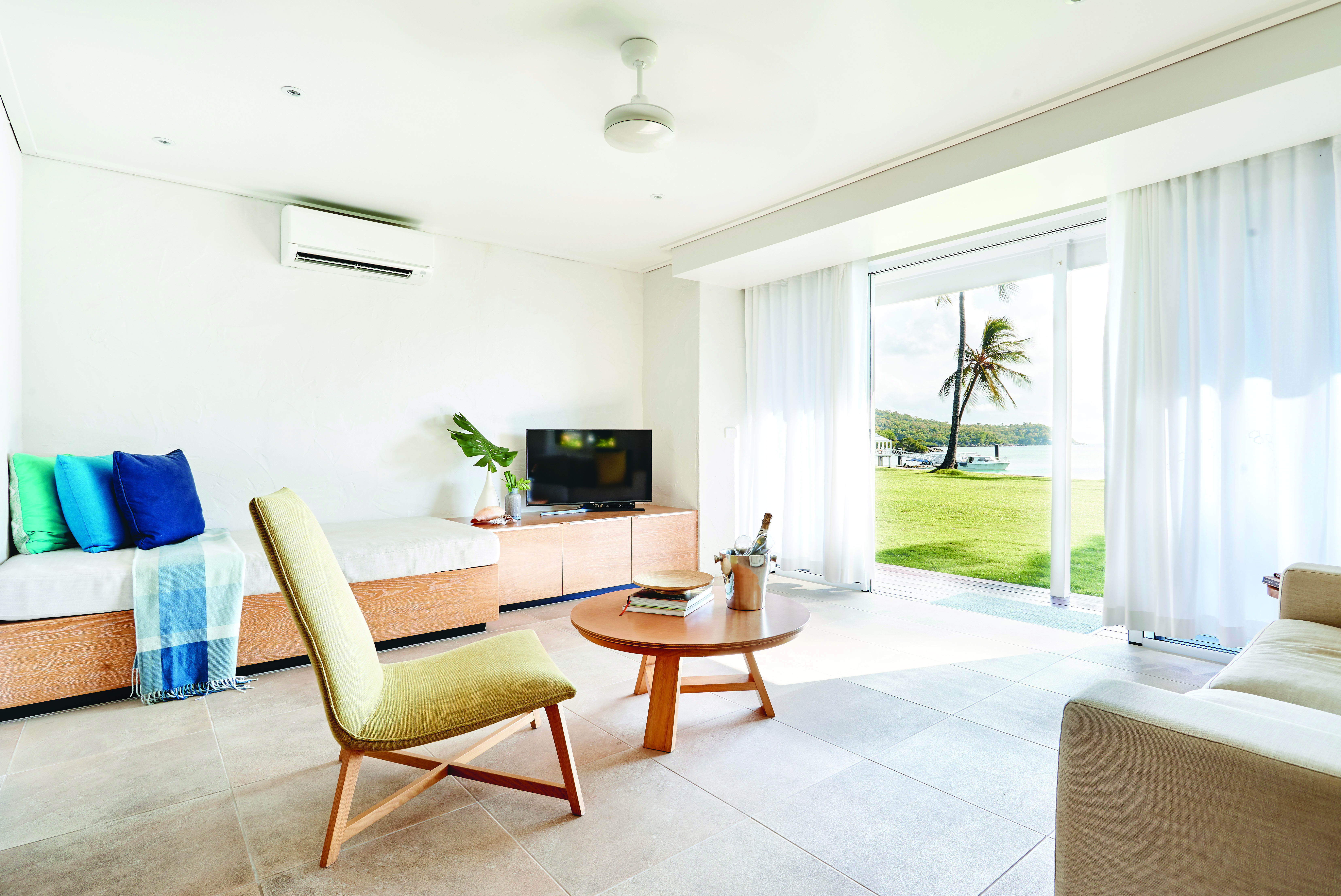 Orpheus Island north suite living area, sofa, chair, day bed, doors leading to beach, bright modern decor