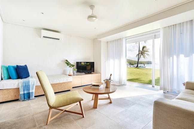 Orpheus Island north suite living area, sofa, chair, day bed, doors leading to beach, bright modern decor