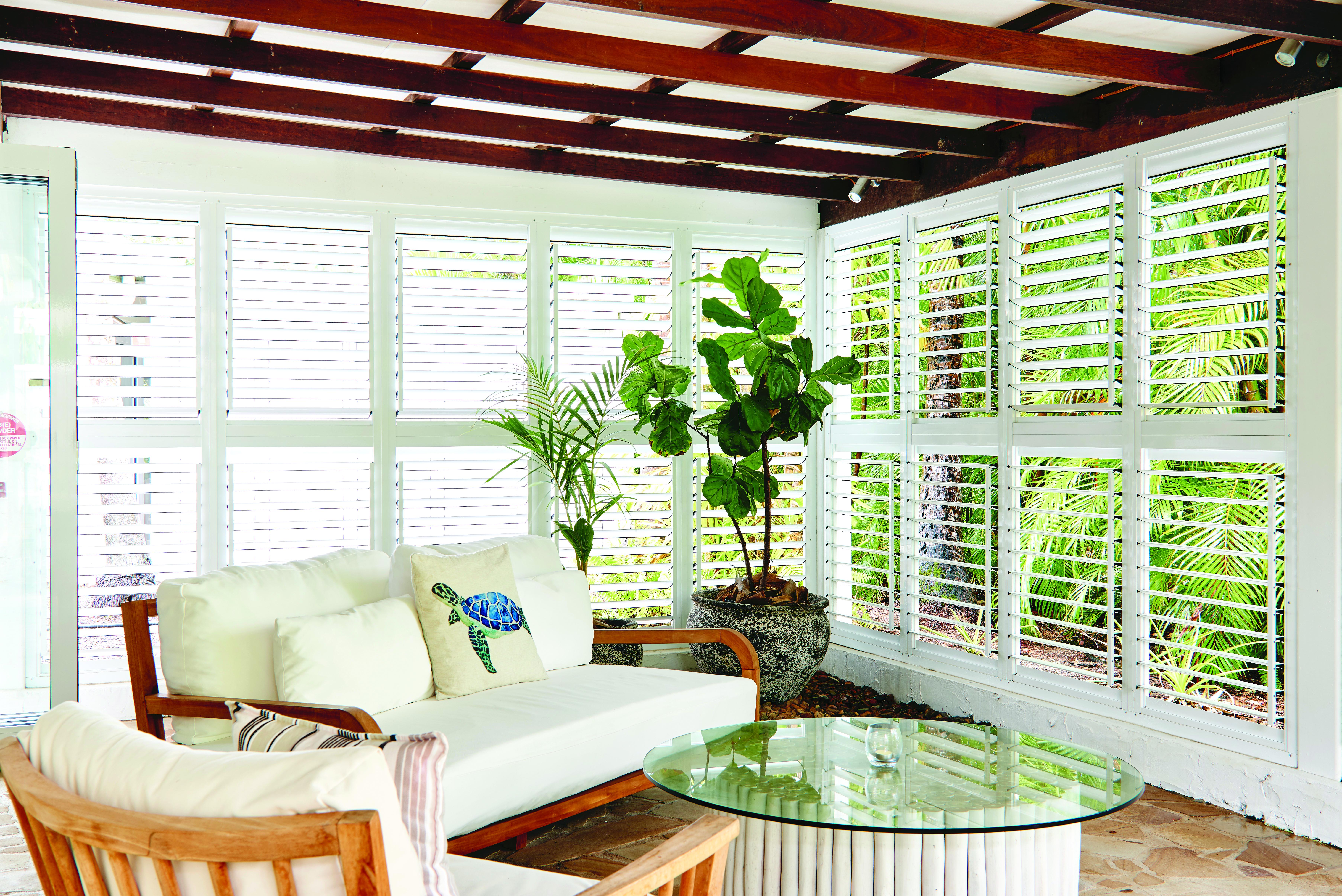 Orpheus Island south suite living area, sofa and armchair, windowed walls with nature views, bright modern decor