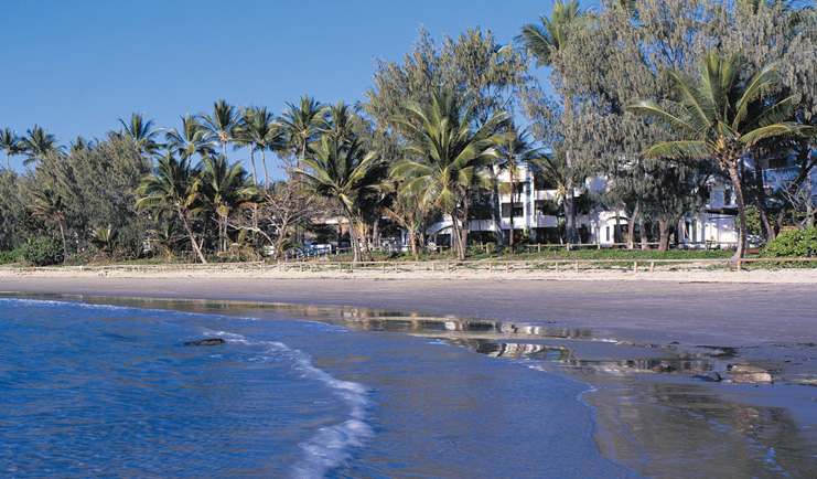 Port Douglas Peninsula Queensland beach front white building and palm trees near beach and sea