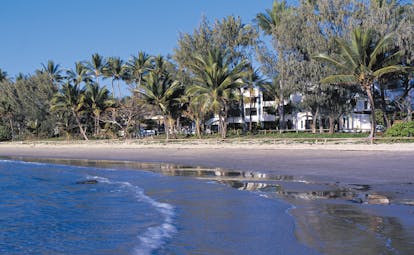 Port Douglas Peninsula Queensland beach front white building and palm trees near beach and sea