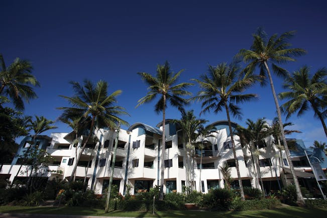 Port Douglas Peninsula Queensland exterior several white buildings with palm trees and blue sky