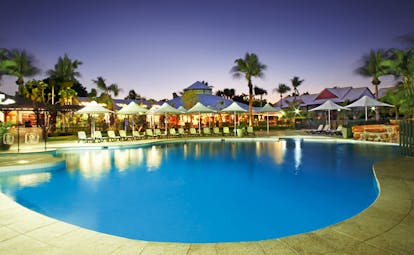 Port Douglas Peninsula Queensland family pool at night with loungers and umbrellas
