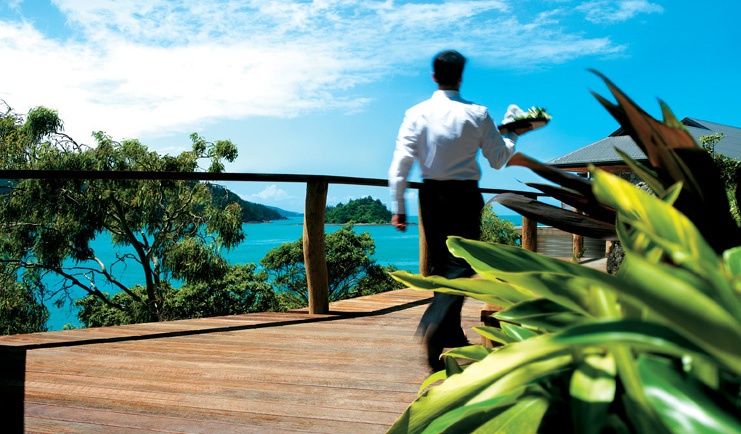Qualia Hamilton Island Queensland boardwalk waiter with tray walking along a boardwalk