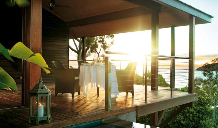 Qualia Hamilton Island Queensland outdoor dining area on covered deck with sea view