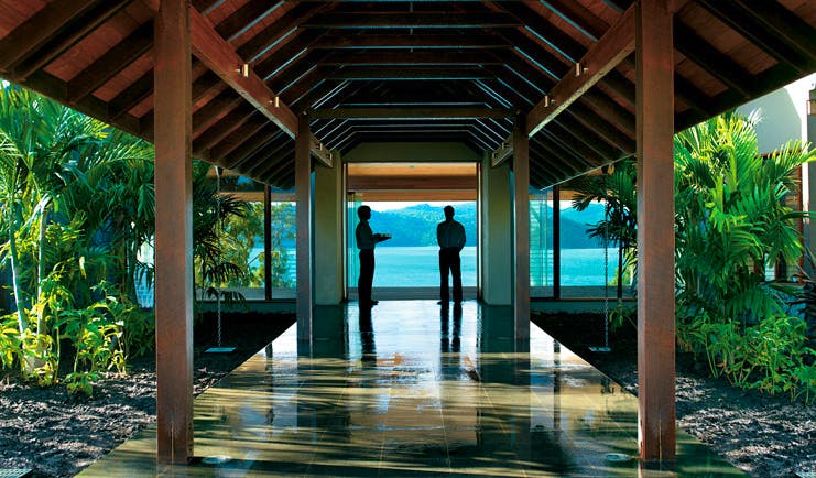 Qualia Hamilton Island Queensland pavilion waiters at the end of a covered pavilion with sea view