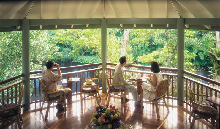 Silky Oaks Lodge Queensland terrace people sitting on a covered terrace overlooking water and trees