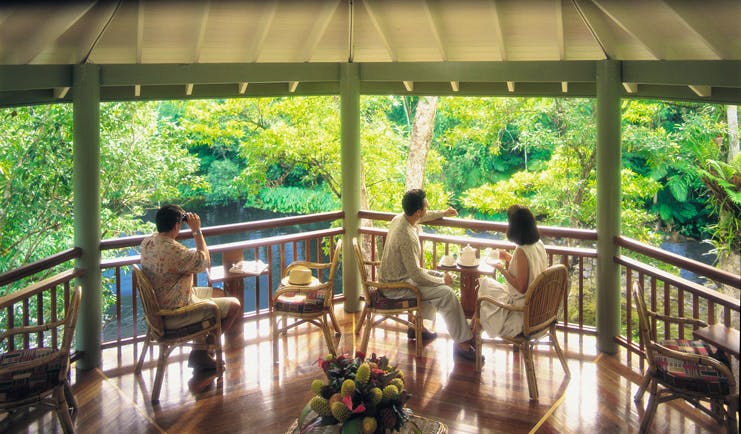 Silky Oaks Lodge Queensland terrace people sitting on a covered terrace overlooking water and trees