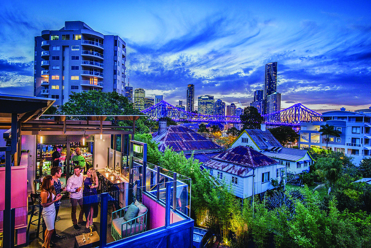 Rooftop bar looking over city at night time