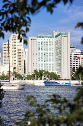 Stamford Plaza Brisbane Queensland exterior white skyscraper with sign reading 'Stamford Plaza'