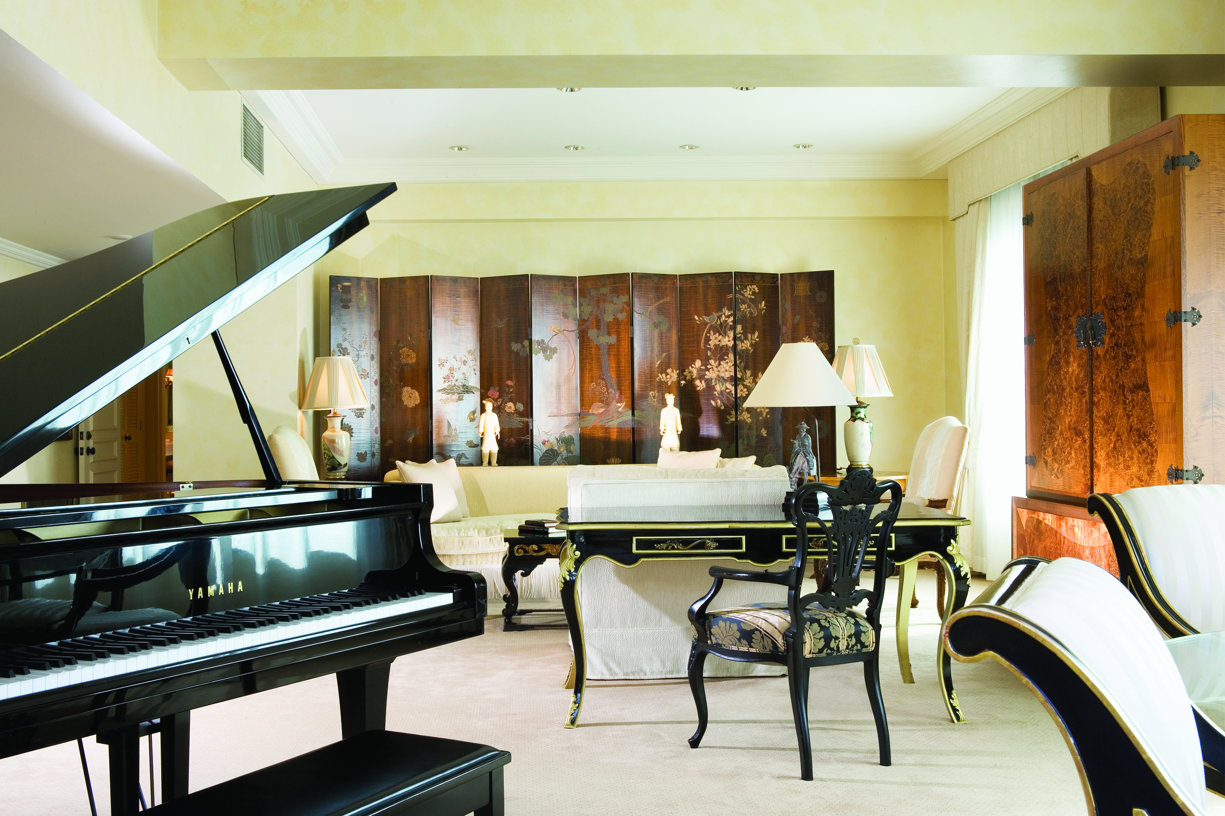 Stamford Plaza Brisbane Queensland suite lounge with sofas desk and grand piano