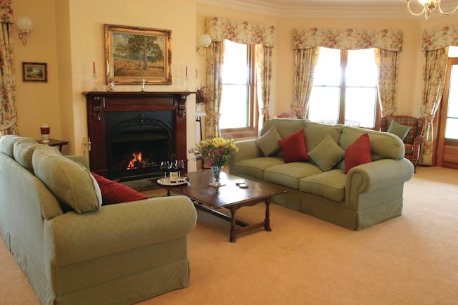 Abbotsford Country House South Australia lounge with sofas and armchairs and fireplace