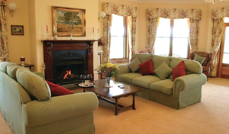 Abbotsford Country House South Australia lounge with sofas and armchairs and fireplace