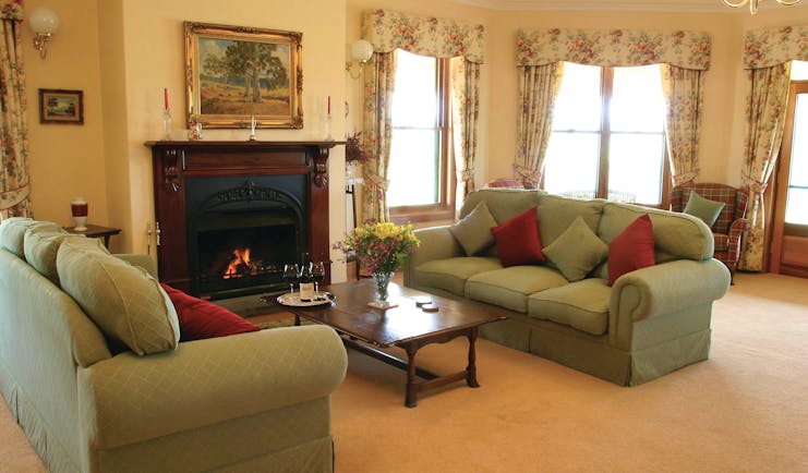 Abbotsford Country House South Australia lounge with sofas and armchairs and fireplace