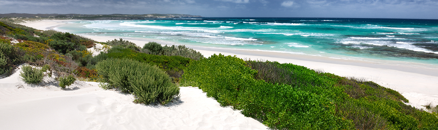 White sand beach with surf and turquoise sea