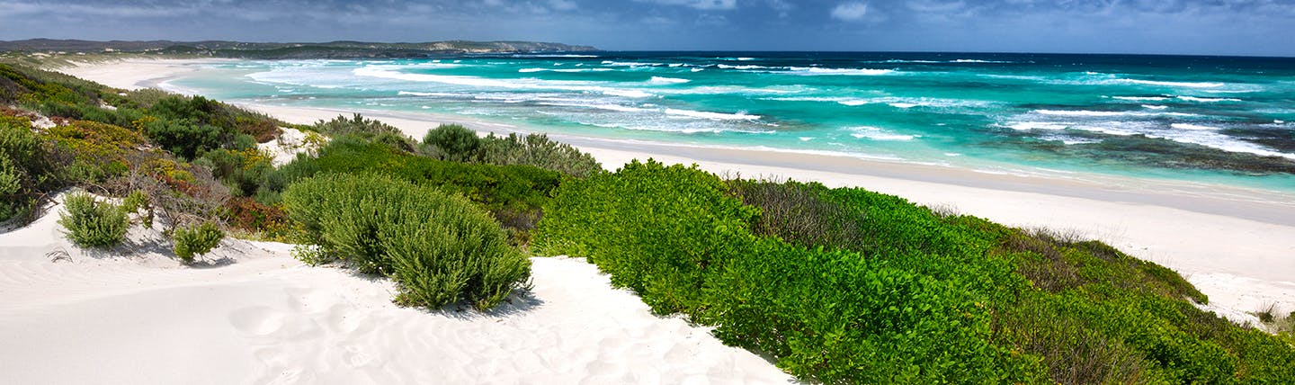 White sand beach with surf and turquoise sea