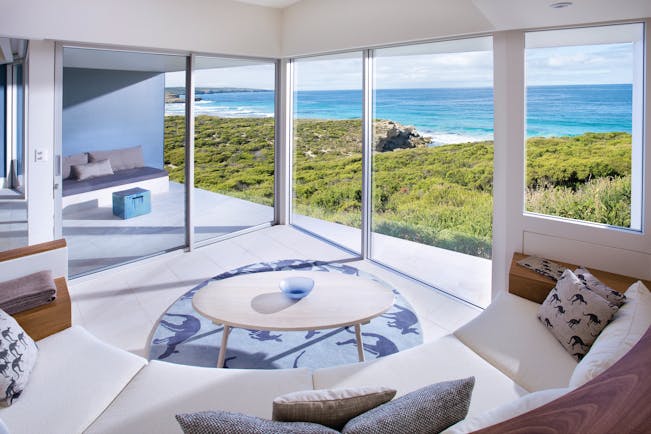 Southern Ocean Lodge Flinders suite lounge, sofa and coffee table, modern decor, large windows leading to private terrace, views over the sea