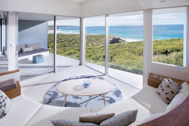 Southern Ocean Lodge Flinders suite lounge, sofa and coffee table, modern decor, large windows leading to private terrace, views over the sea
