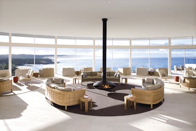 Lounge area with lagre window pannelled walls looking over the sea and seatings area