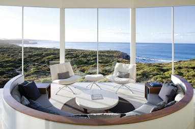 Southern Ocean Lodge osprey pavilion lounge, modern seating area with panoramic views over coastline and sea