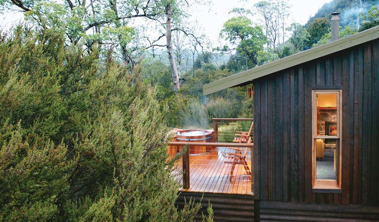 Cradle Mountain Lodge Tasmania balcony hot tub wood cabin with decked balcony with hot tub and forest view