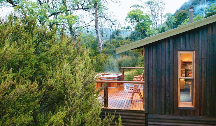 Cradle Mountain Lodge Tasmania balcony hot tub wood cabin with decked balcony with hot tub and forest view