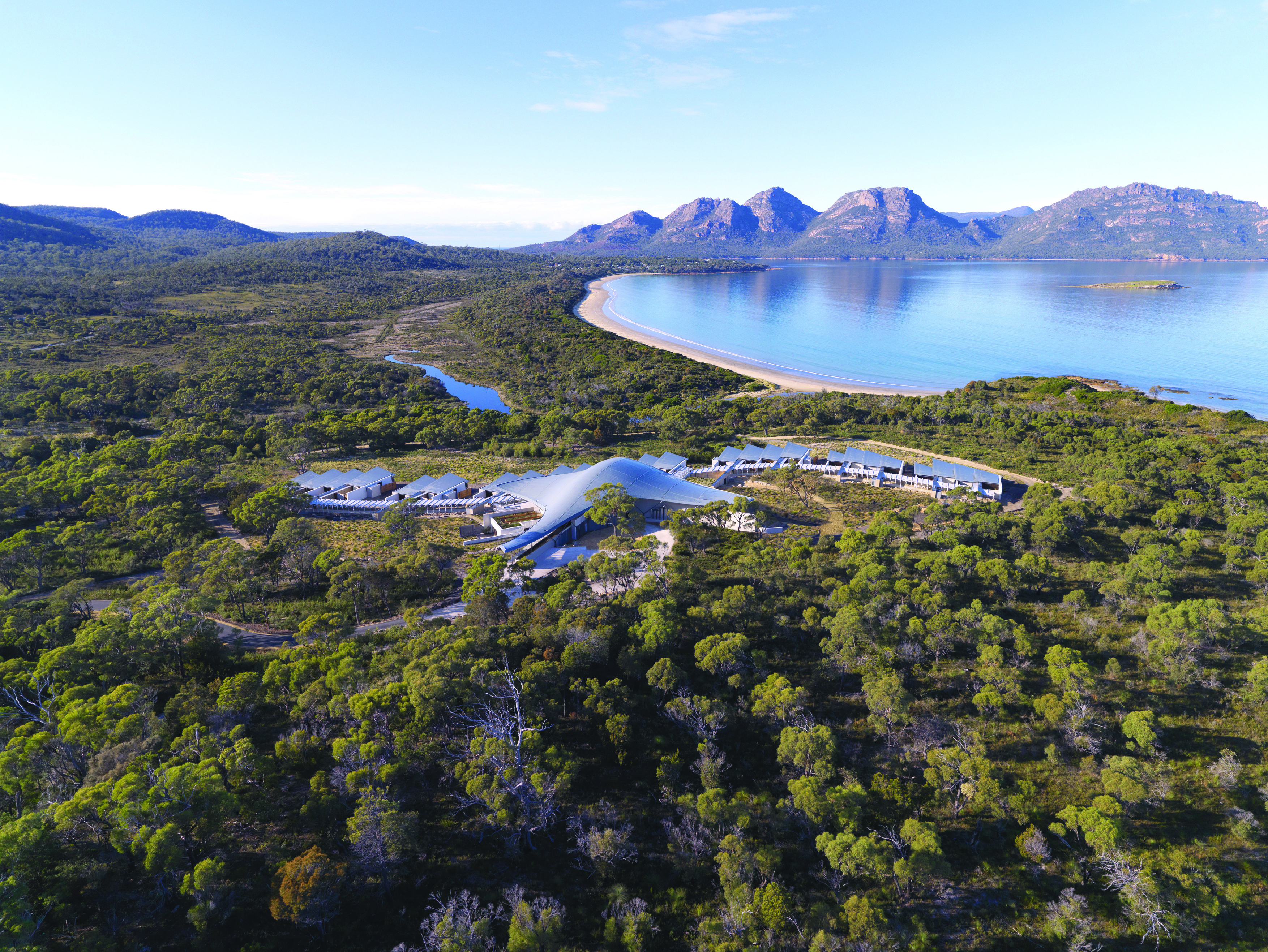 Saffire Freycinet Tasmania aerial view of a futuristic building in wooded area near the coast