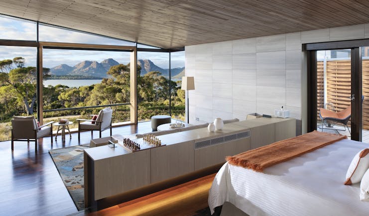 Saffire Freycinet Tasmania deluxe suite with floor to ceiling windows and seating area with mountain view