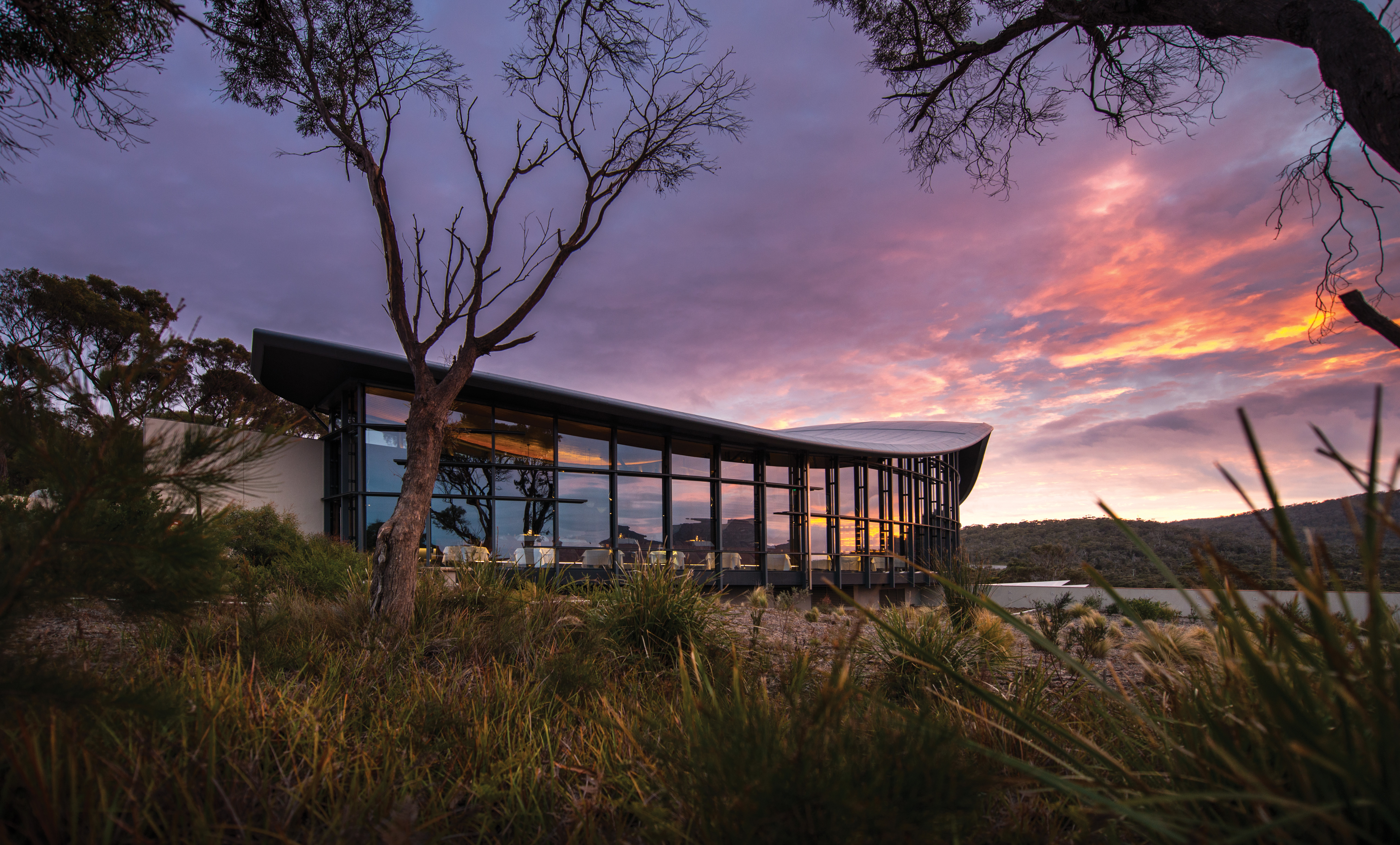 Saffire Freycinet Tasmania exterior sunrise view of futuristic building with large windows
