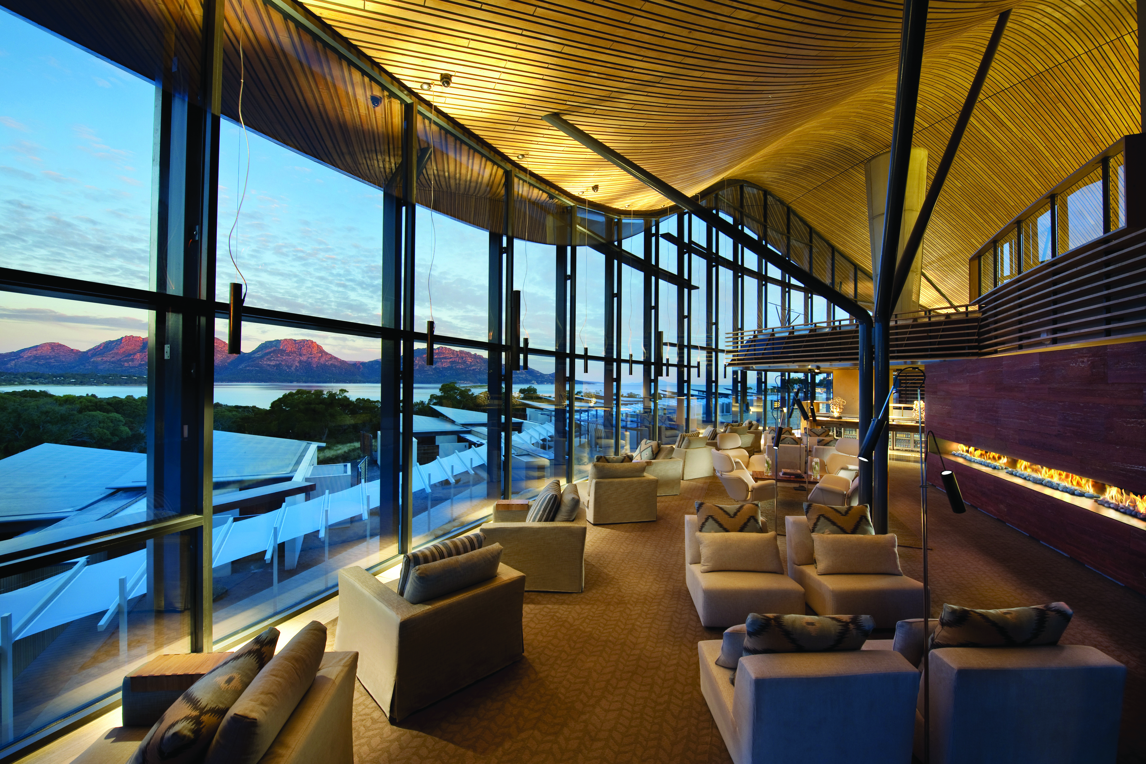 Saffire Freycinet Tasmania lounge with floor to ceiling windows overlooking mountains and sea
