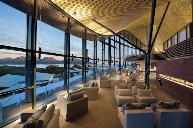 Saffire Freycinet Tasmania lounge with floor to ceiling windows overlooking mountains and sea