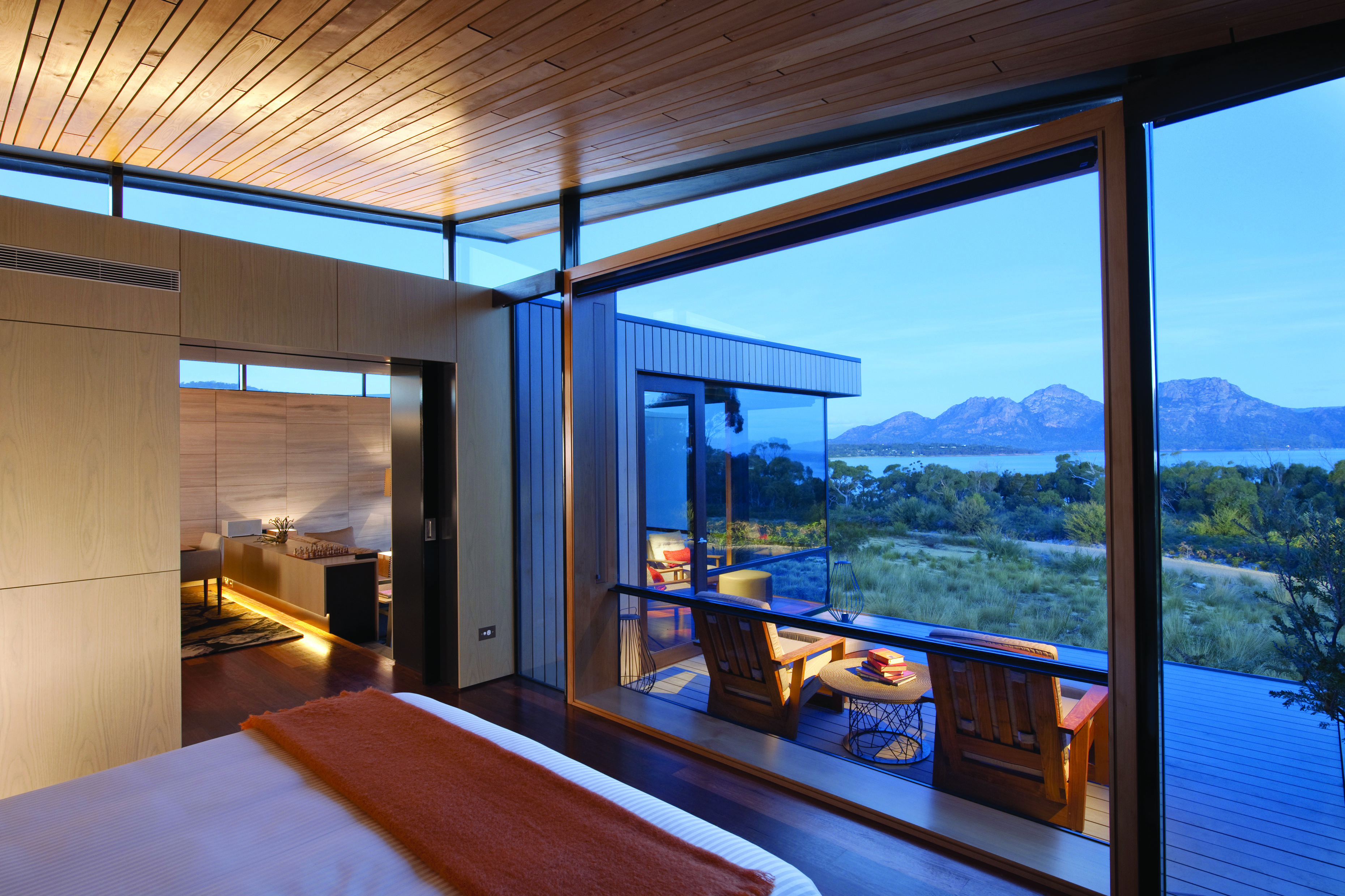 Saffire Freycinet Tasmania premium suite with large windows leading to deck with mountain and sea view