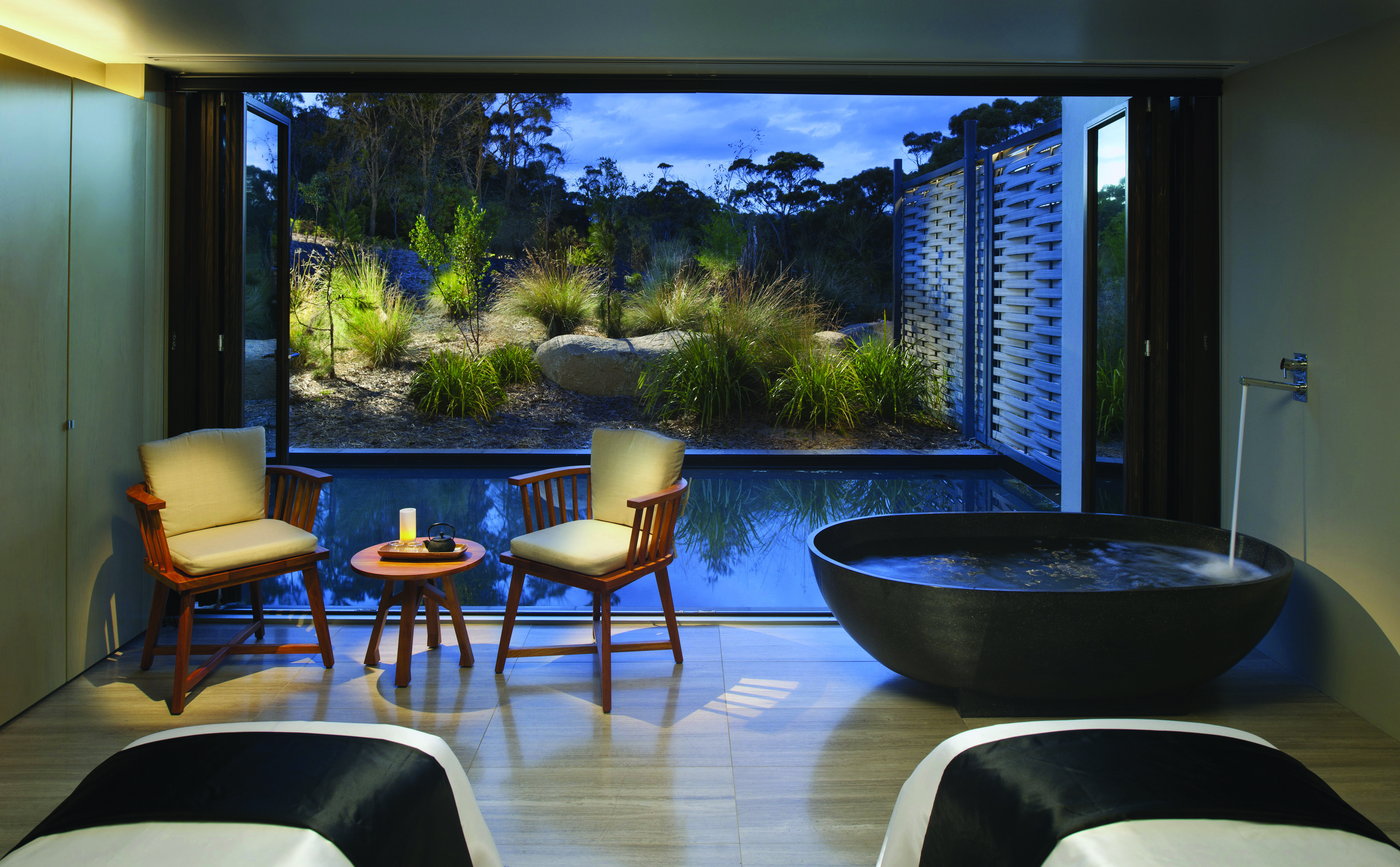 Saffire Freycinet Tasmania spa area with a freestanding bath and patio doors to outdoor pool